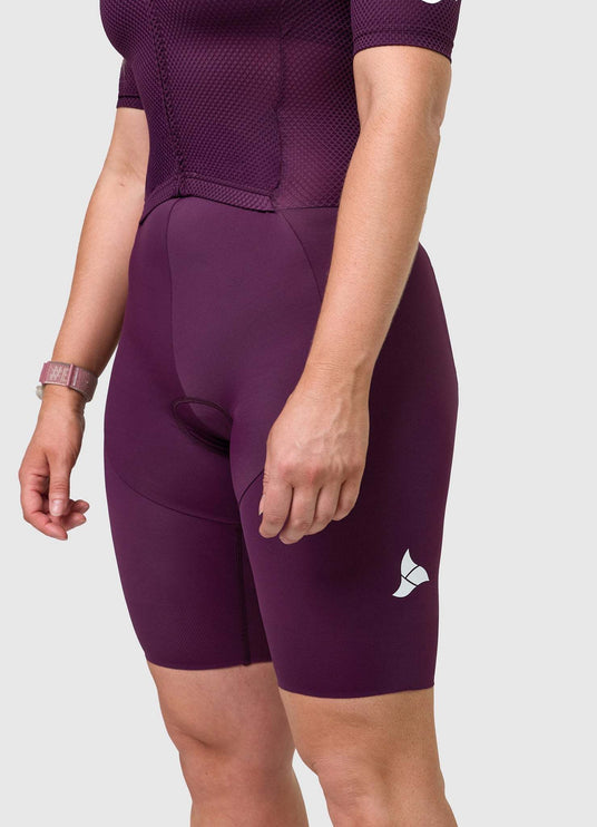 Side angle of TRI-FIT women’s VANGUARD tri-suit in plum showing ergonomic fit and panel shaping